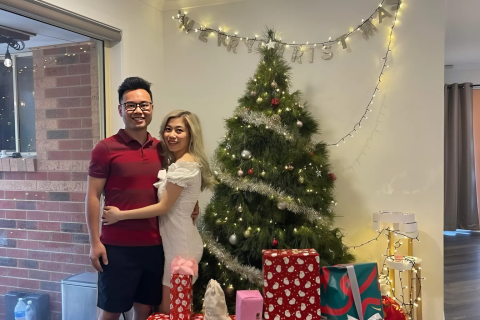 Happy couple celebrates Christmas in July with real Christmas tree